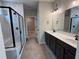 Modern bathroom with marble shower stall and vanity with dual sinks and sleek, dark wood cabinetry at 115 Laurel Farms Ln, Dallas, GA 30157
