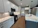 Contemporary kitchen featuring sleek cabinetry, granite countertops, a gas range, and stainless steel microwave at 115 Laurel Farms Ln, Dallas, GA 30157