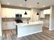 Modern kitchen features white cabinets, stainless steel appliances, and a center island with quartz countertop at 115 Laurel Farms Ln, Dallas, GA 30157