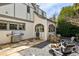 Charming backyard featuring a stone patio, outdoor grill, fire pit, and lush greenery at 1666 Johnson Ne Rd, Atlanta, GA 30306