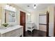 Bright bathroom featuring double vanities with marble countertops, dark wood floors, and stylish fixtures at 1666 Johnson Ne Rd, Atlanta, GA 30306