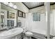 Classic bathroom featuring a pedestal sink, soaking tub, and decorative mirror at 1666 Johnson Ne Rd, Atlanta, GA 30306