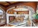 Formal dining room featuring wood floors, stone archway, decorative mirrors, and custom buffet at 1666 Johnson Ne Rd, Atlanta, GA 30306