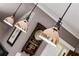 A close up of three copper pendant lights hanging over the kitchen island at 1666 Johnson Ne Rd, Atlanta, GA 30306