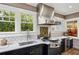 Gourmet kitchen featuring modern appliances, white subway tile, and large windows with backyard views at 1666 Johnson Ne Rd, Atlanta, GA 30306