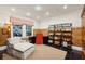 Comfortable living room featuring a chaise lounge, dark wood floors, and shelving with books at 1666 Johnson Ne Rd, Atlanta, GA 30306