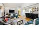 Open-concept living room featuring hardwood floors, modern furniture, and a view of the bar area at 1666 Johnson Ne Rd, Atlanta, GA 30306