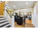 Staircase leads to an open concept living space with a bar counter and hardwood floors at 1666 Johnson Ne Rd, Atlanta, GA 30306