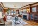 Cozy living room with wood trim, fireplace, hardwood floors, and natural light at 1666 Johnson Ne Rd, Atlanta, GA 30306
