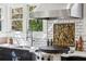 Close-up of an outdoor kitchen with built-in grill, sink, and subway tile backsplash at 1666 Johnson Ne Rd, Atlanta, GA 30306