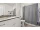 Bathroom featuring gray vanity with sink, shower and white walls at 304 Gibson Se St, Atlanta, GA 30316