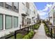 Modern white townhome exteriors with sidewalks, black trim and landscaping at 304 Gibson Se St, Atlanta, GA 30316