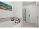 Modern bathroom featuring a tub and glass-enclosed shower with a beachy decorative theme at 4414 Declan Dr, Kennesaw, GA 30144