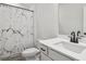 This modern bathroom features a marble pattern shower curtain and matte black hardware at 4414 Declan Dr, Kennesaw, GA 30144
