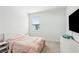 Comfortable bedroom with soft pink bedding, modern TV and dresser at 4414 Declan Dr, Kennesaw, GA 30144