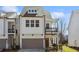A modern two-story home with a brown garage door and a small second story porch at 4414 Declan Dr, Kennesaw, GA 30144