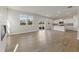 Open floor plan view with fireplace and modern kitchen with stainless appliances and kitchen island at 650 Redhead Way (Lot 25), Grayson, GA 30017
