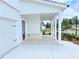Covered porch with white columns, brick accents, and concrete flooring creates an inviting entry at 650 Redhead Way (Lot 25), Grayson, GA 30017
