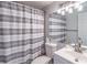 Bathroom featuring a stylish vanity, toilet, mirror, and shower with gray and white striped curtain at 1501 Clairmont Rd # 2016, Decatur, GA 30033