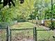 Well-maintained dog park area with secure fencing, lush greenery, and convenient waste disposal for pet-friendly community living at 1501 Clairmont Rd # 2016, Decatur, GA 30033