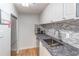 Compact kitchen with white cabinets, stainless steel sink, and gray backsplash at 1501 Clairmont Rd # 2016, Decatur, GA 30033