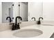 Close-up of bathroom vanity featuring double sinks, quartz countertop and modern fixtures at 1696 Gunnin Nw Trce # 244, Atlanta, GA 30318