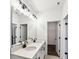 Bathroom featuring double sink vanity with an oversized mirror and a walk-in closet at 1696 Gunnin Nw Trce # 244, Atlanta, GA 30318