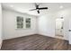 Sunlit bedroom with a ceiling fan, a window view, and an open doorway to an ensuite bathroom at 1696 Gunnin Nw Trce # 244, Atlanta, GA 30318