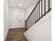 Bright foyer featuring hardwood floors, a staircase, and a view of the front door at 1696 Gunnin Nw Trce # 244, Atlanta, GA 30318