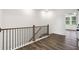 Hallway featuring hardwood floors, a decorative railing and ample natural light at 1696 Gunnin Nw Trce # 244, Atlanta, GA 30318