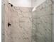 Walk-in shower with marble-style tiling and black trim at 1696 Gunnin Nw Trce # 244, Atlanta, GA 30318