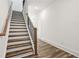 Modern staircase with wood treads, iron railings, and natural light, enhancing the home's interior at 1696 Gunnin Nw Trce # 244, Atlanta, GA 30318