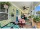 Relaxing back porch with comfortable seating, ceiling fan, and views of the serene backyard at 410 Bowen Ne Rd, White, GA 30184