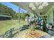 Cozy screened back porch with comfortable seating and views of the backyard at 410 Bowen Ne Rd, White, GA 30184