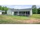 Home's backyard features screened in porch, fenced yard and well maintained lawn at 410 Bowen Ne Rd, White, GA 30184