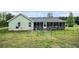 Home's backyard features screened in porch, fenced yard and well maintained lawn at 410 Bowen Ne Rd, White, GA 30184