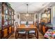 Elegant dining room featuring wood floors, decorative lighting, and classic furnishings at 410 Bowen Ne Rd, White, GA 30184