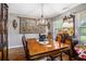 Charming dining room with wood floors and a decorative tapestry at 410 Bowen Ne Rd, White, GA 30184