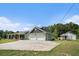 Charming home exterior with a large, paved driveway, two-car garage, covered porch, and a well-maintained lawn at 410 Bowen Ne Rd, White, GA 30184
