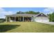 Charming home with a covered front porch, two-car garage, and lush green lawn at 410 Bowen Ne Rd, White, GA 30184