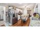 Bright kitchen featuring white cabinets and stainless steel appliances with wood floors at 410 Bowen Ne Rd, White, GA 30184