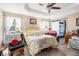 Cozy bedroom with tray ceilings, ample natural light, and a private ensuite at 410 Bowen Ne Rd, White, GA 30184