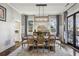 Bright dining room featuring a stylish light fixture, hardwood floors, and large windows at 100 Daniel Se Ave, Atlanta, GA 30317