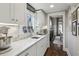 Bright kitchen with white cabinets, marble countertops, stainless appliances, and access to the dining area at 100 Daniel Se Ave, Atlanta, GA 30317