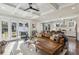 Open living room featuring a coffered ceiling, hardwood floors, and seamless transition to the kitchen and outdoor patio at 100 Daniel Se Ave, Atlanta, GA 30317