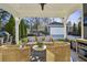 Inviting covered patio with wicker furniture and outdoor grill, perfect for entertaining in a cozy outdoor setting at 100 Daniel Se Ave, Atlanta, GA 30317