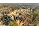 Overhead view of the landscaped grounds surrounding several luxury homes in a wooded community at 12710 Old Surrey Pl, Roswell, GA 30075