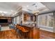 Stylish bar area with wooden cabinets, granite countertops, seating, and wine storage at 12710 Old Surrey Pl, Roswell, GA 30075