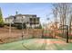 The backyard has an outdoor basketball court with lots of space to run and play at 12710 Old Surrey Pl, Roswell, GA 30075