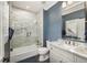 Modern bathroom featuring tiled shower-tub combo, sleek vanity, and stylish fixtures at 12710 Old Surrey Pl, Roswell, GA 30075